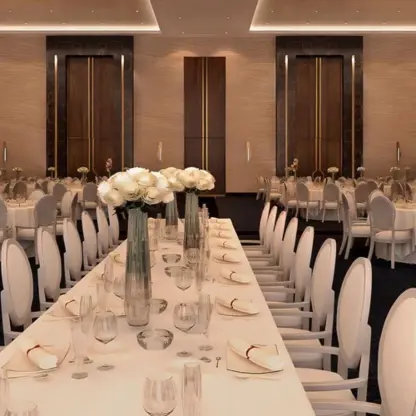 Indoor wedding reception setup with long tables and white floral centerpieces at Le Blanc Spa Resort, Cancun