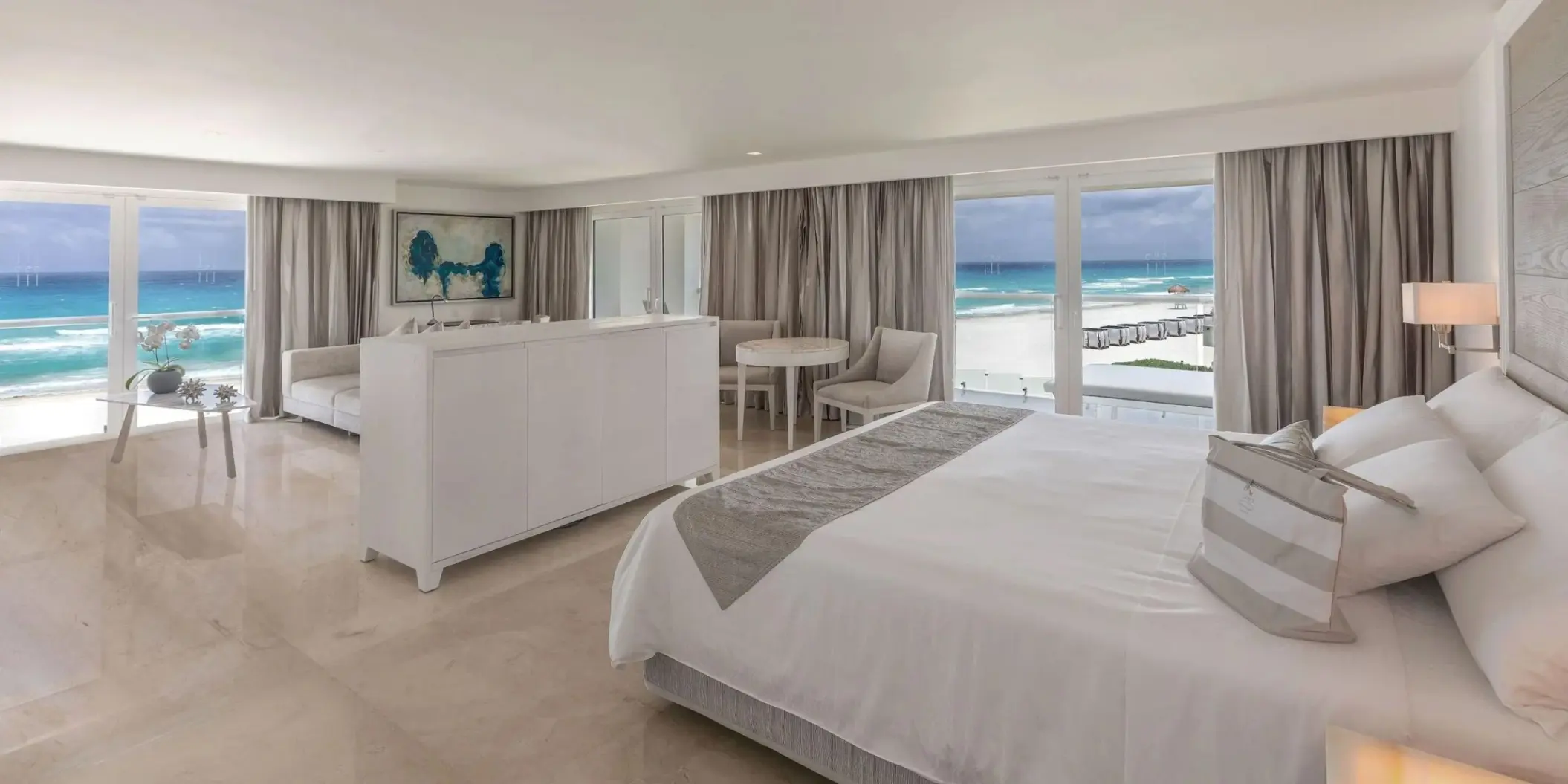 Governor Suite with white bedding and oceanfront views at Le Blanc Spa Resort, Cancun