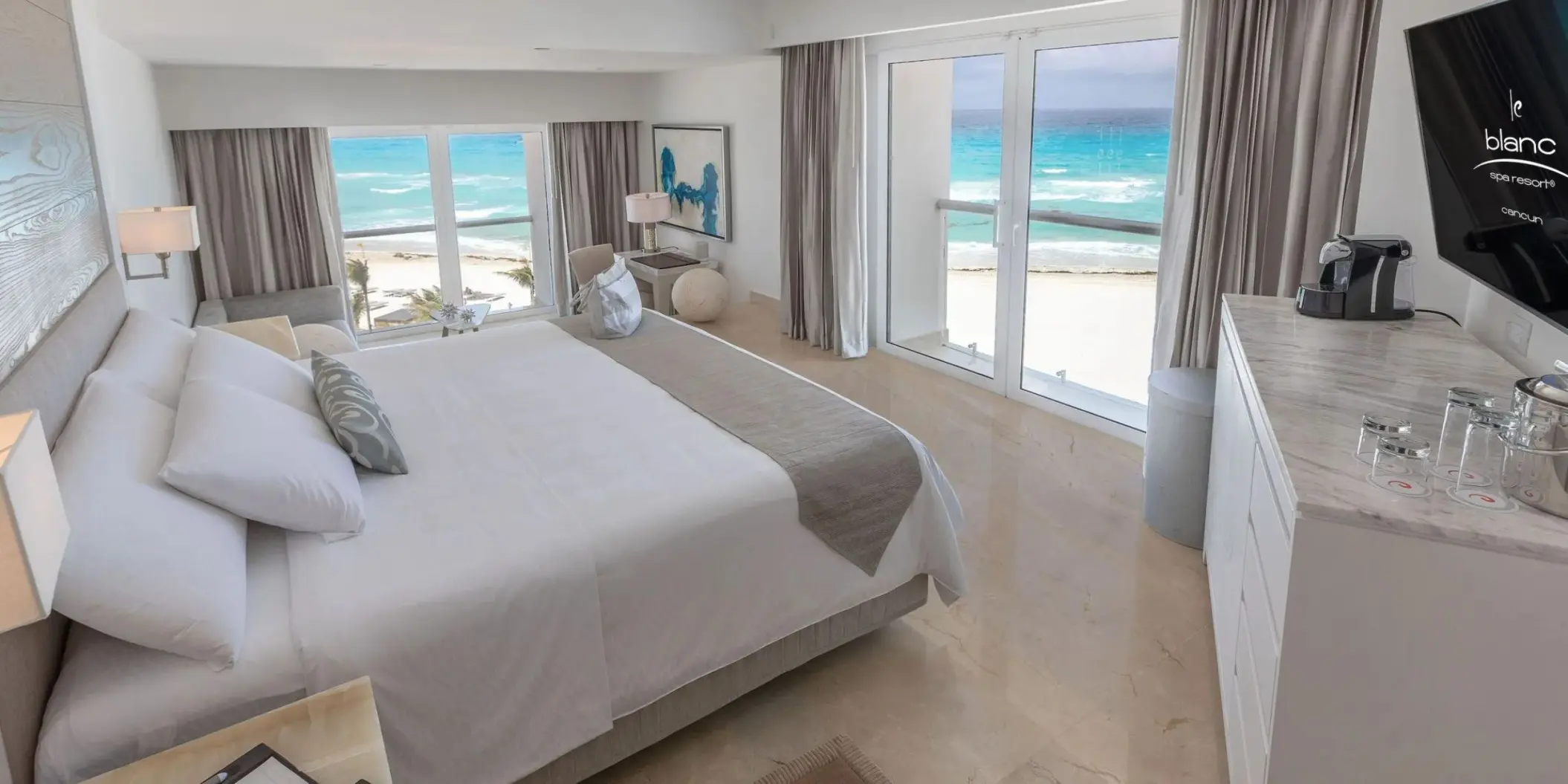 Junior Suite with ocean views and white linens at Le Blanc Spa Cancun