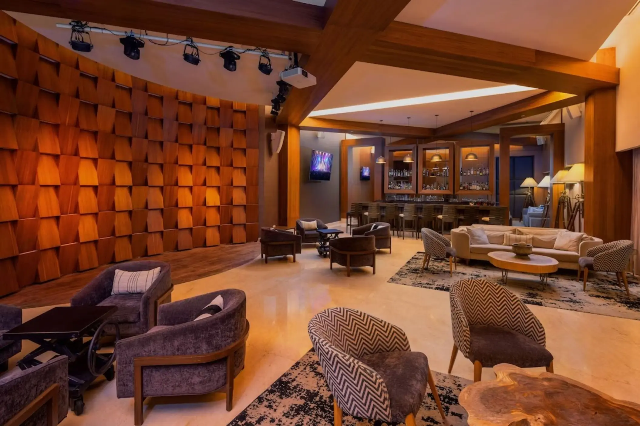 Lounge and bar area with wood-paneled wall and modern seating at Le Blanc Spa Resort, Cancun