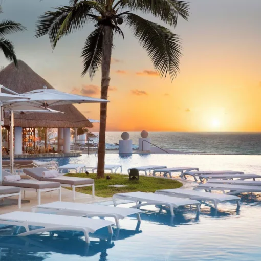pool and loungers at Le Blanc Spa Resort Cancun during sunset