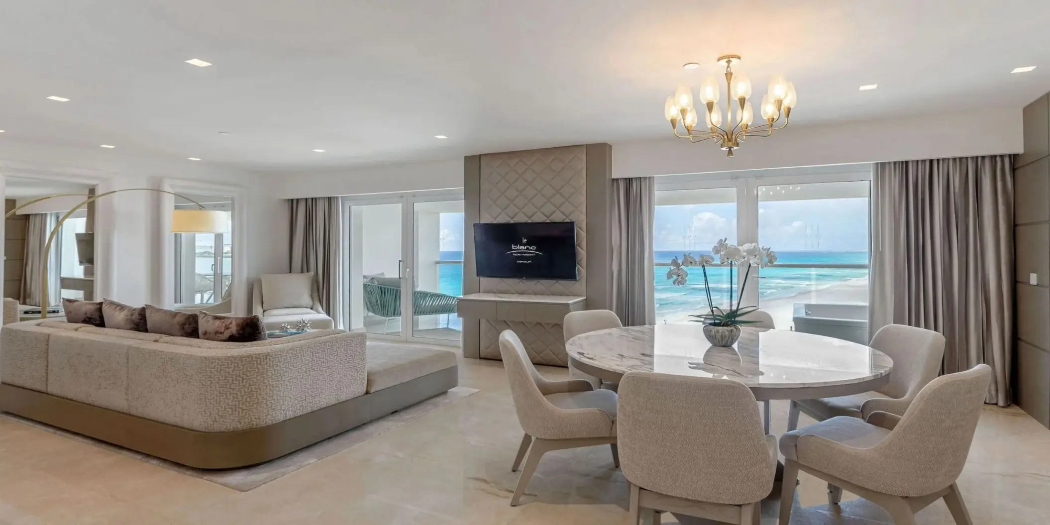 Presidential Suite living and dining area with ocean views at Le Blanc Spa Resort, Cancun