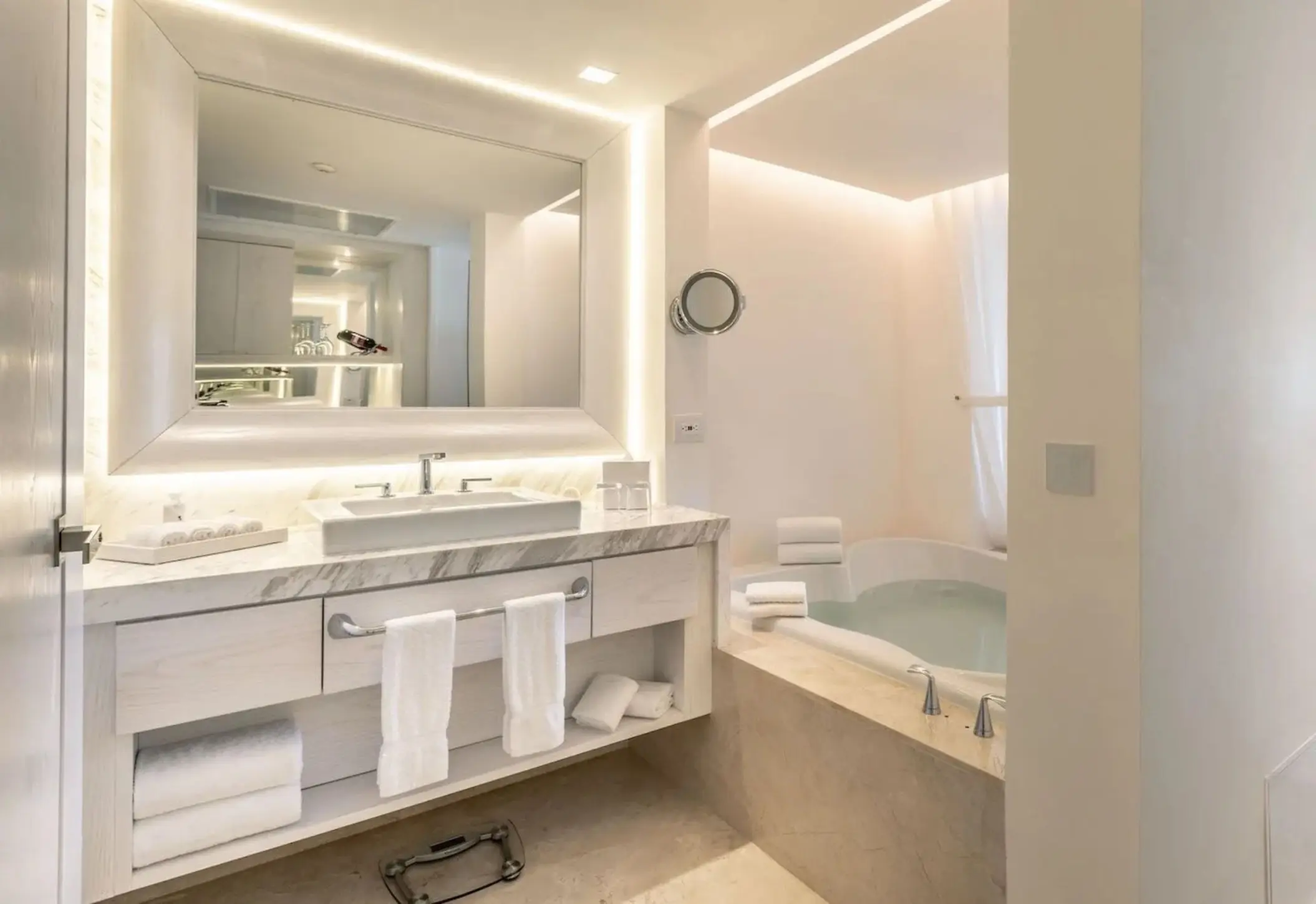 Modern suite washroom with marble vanity and whirlpool tub at Le Blanc Spa Resort, Cancun