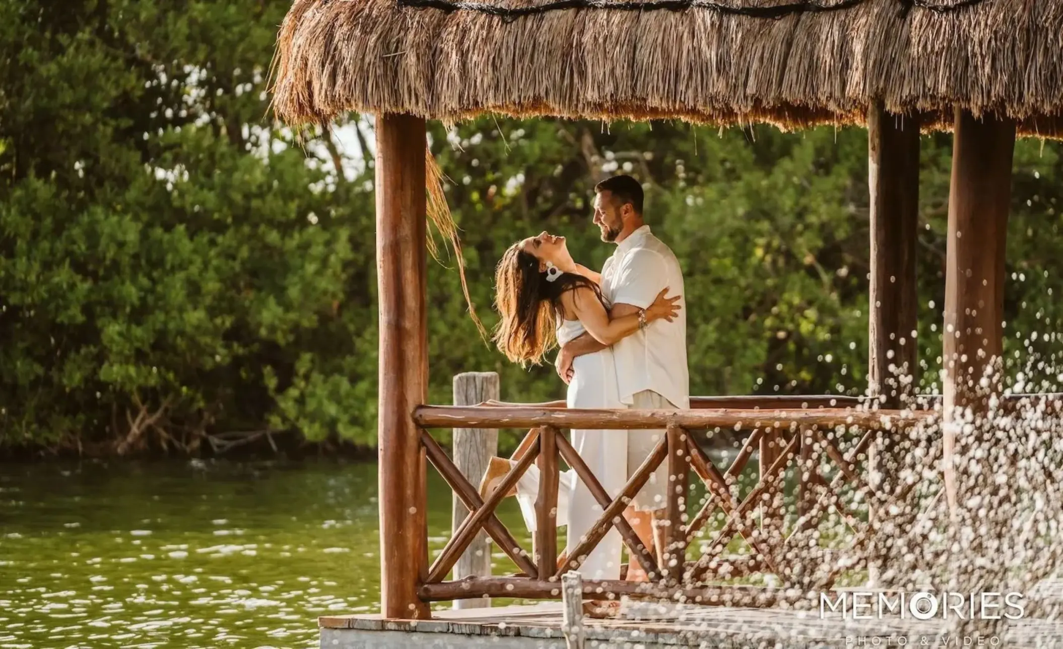 The couple embracing under a thatched gazebo at Le Blanc Spa Resort, Cancun
