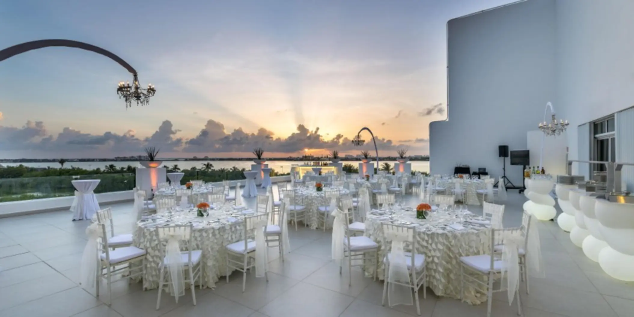 Outdoor wedding reception setup on the Wind Terrace at Le Blanc Spa Resort Cancun during sunset