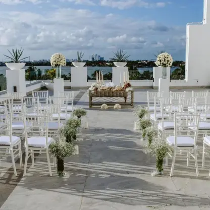 Wind Terrace wedding ceremony setup with white chairs overlooking the lagoon at Le Blanc Spa Resort, Cancun