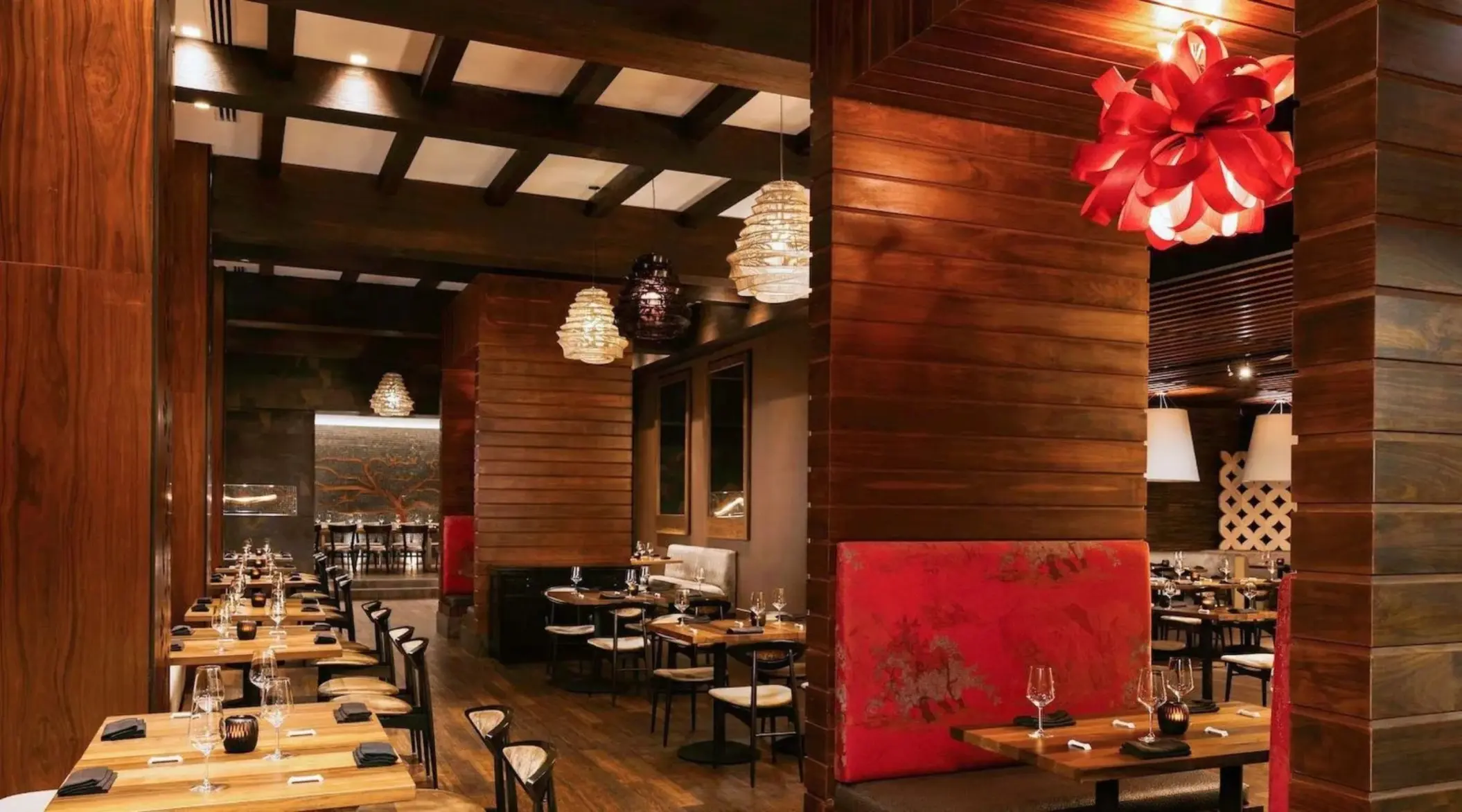 Yama restaurant with wood paneled walls and red light fixtures at Le Blanc Spa Resort, Cancun