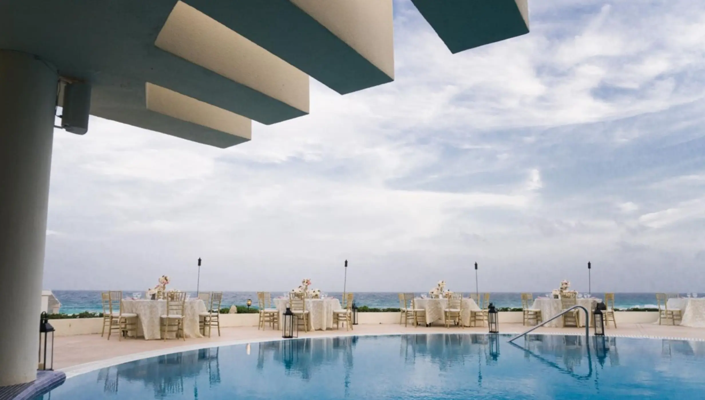 Poolside wedding reception setup overlooking the ocean at Live Aqua Cancun, Cancun