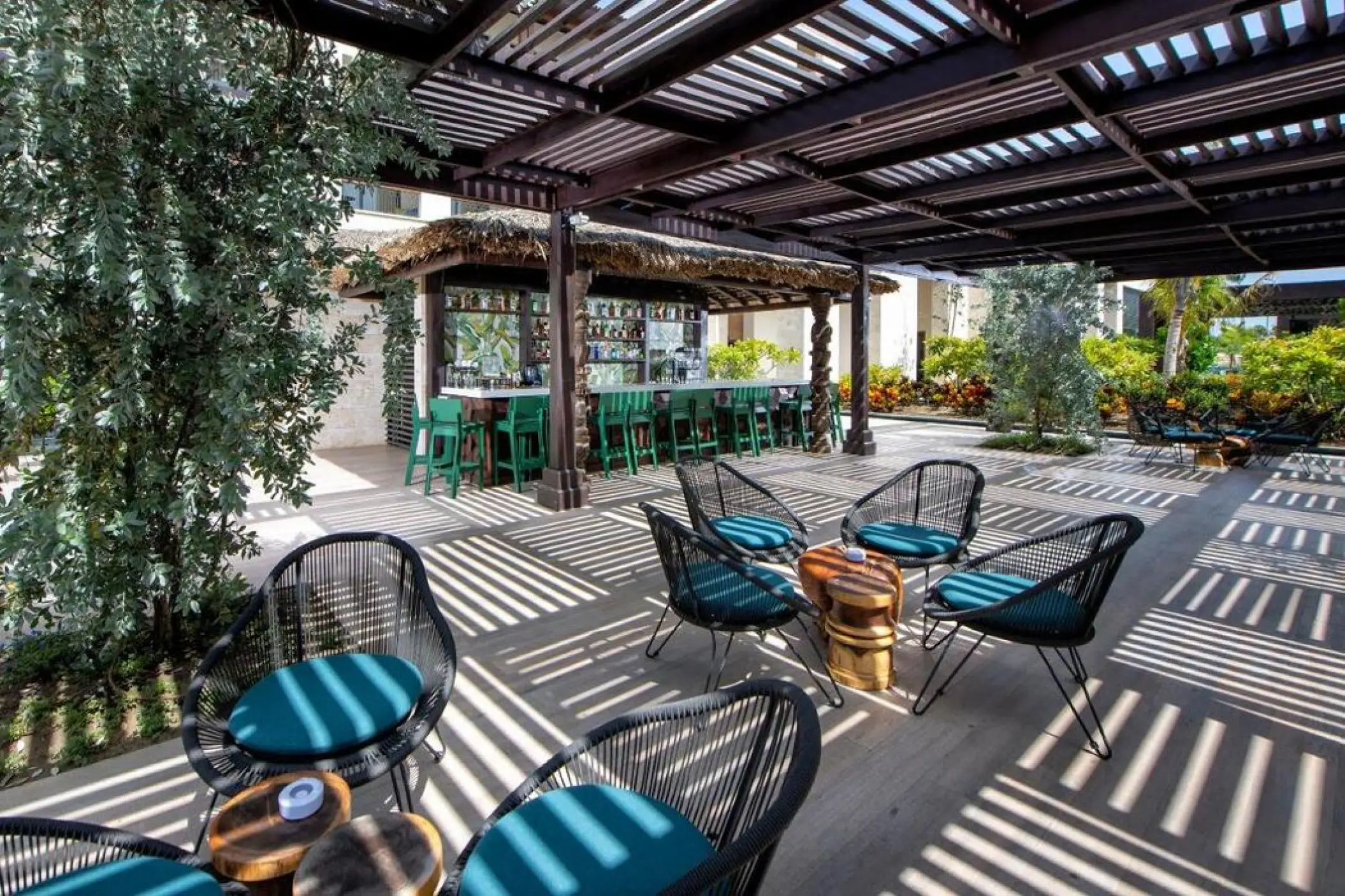 Outdoor bar and lounge seating area under a pergola at Lopesan Costa Bavaro, Punta Cana