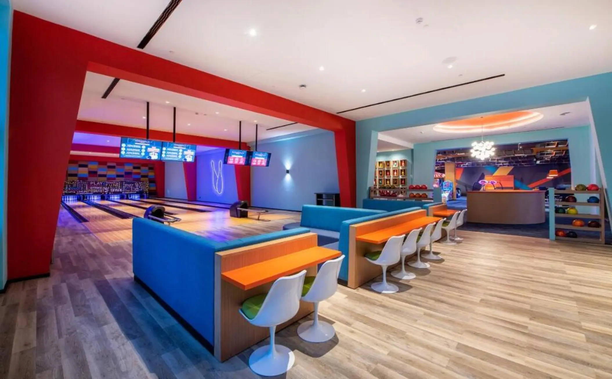 Bowling alley with colorful seating and multiple lanes at Lopesan Costa Bavaro, Punta Cana
