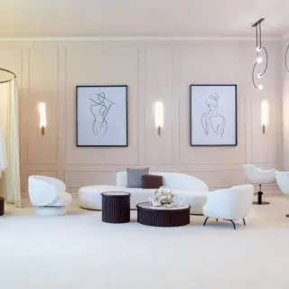 Bridal getting ready suite with white seating and hanging wedding dress at Lopesan Costa Bavaro, Punta Cana