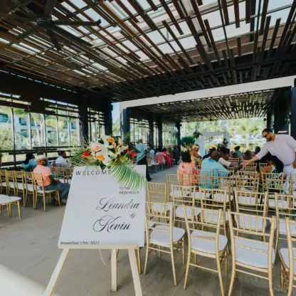 Leandra & Kevin's wedding ceremony setup under a covered terrace at Lopesan Costa Bavaro, Punta Cana