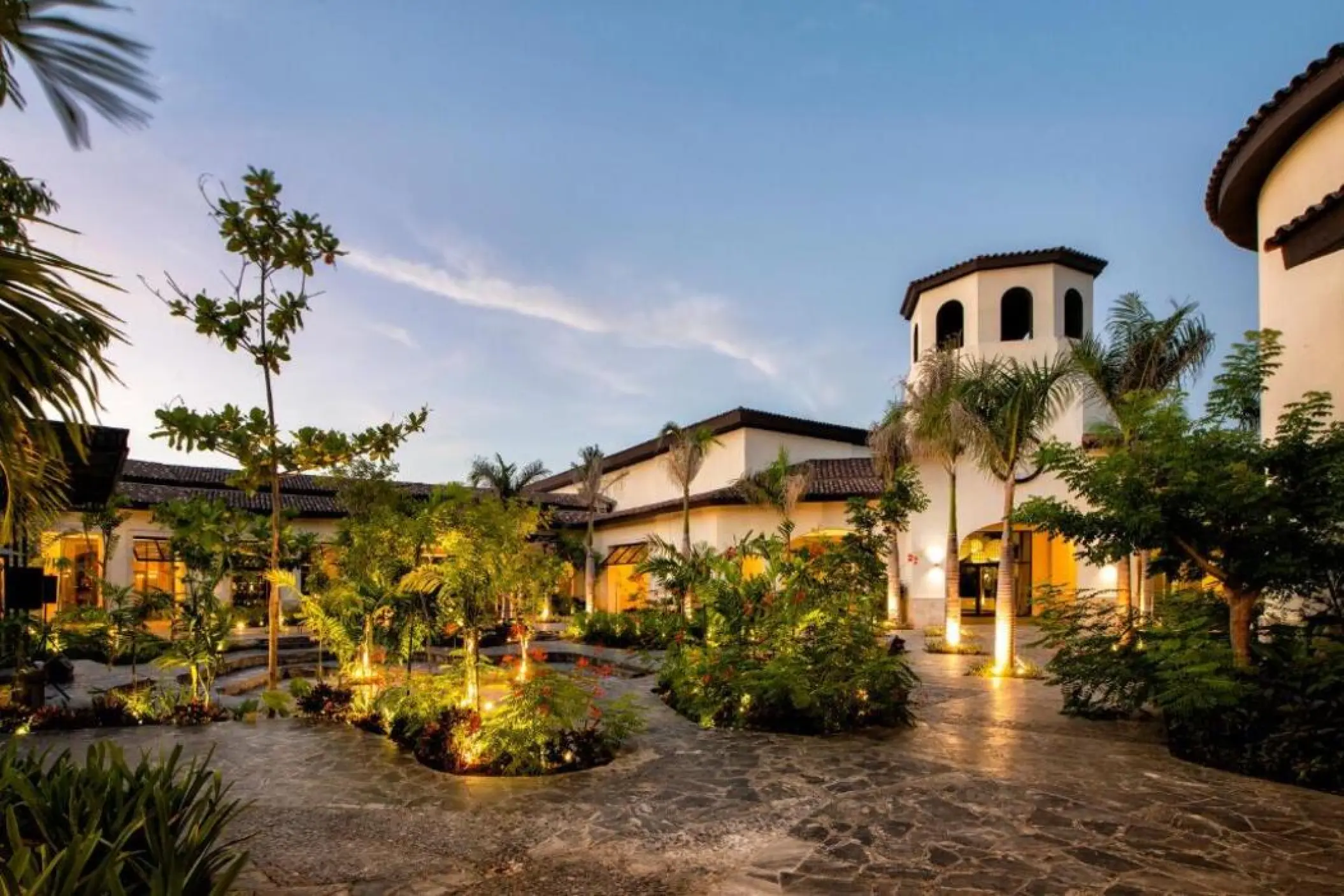 Lopesan Costa Bavaro exterior walkways and lush gardens lit up at night, Punta Cana