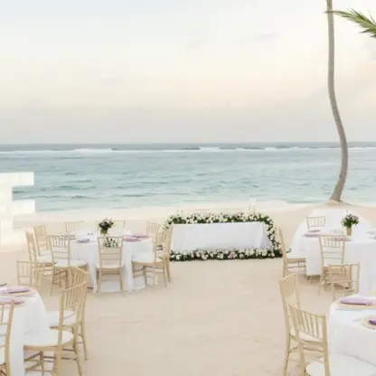 Beachfront wedding reception with LOVE letters and floral decor at Majestic Colonial, Punta Cana