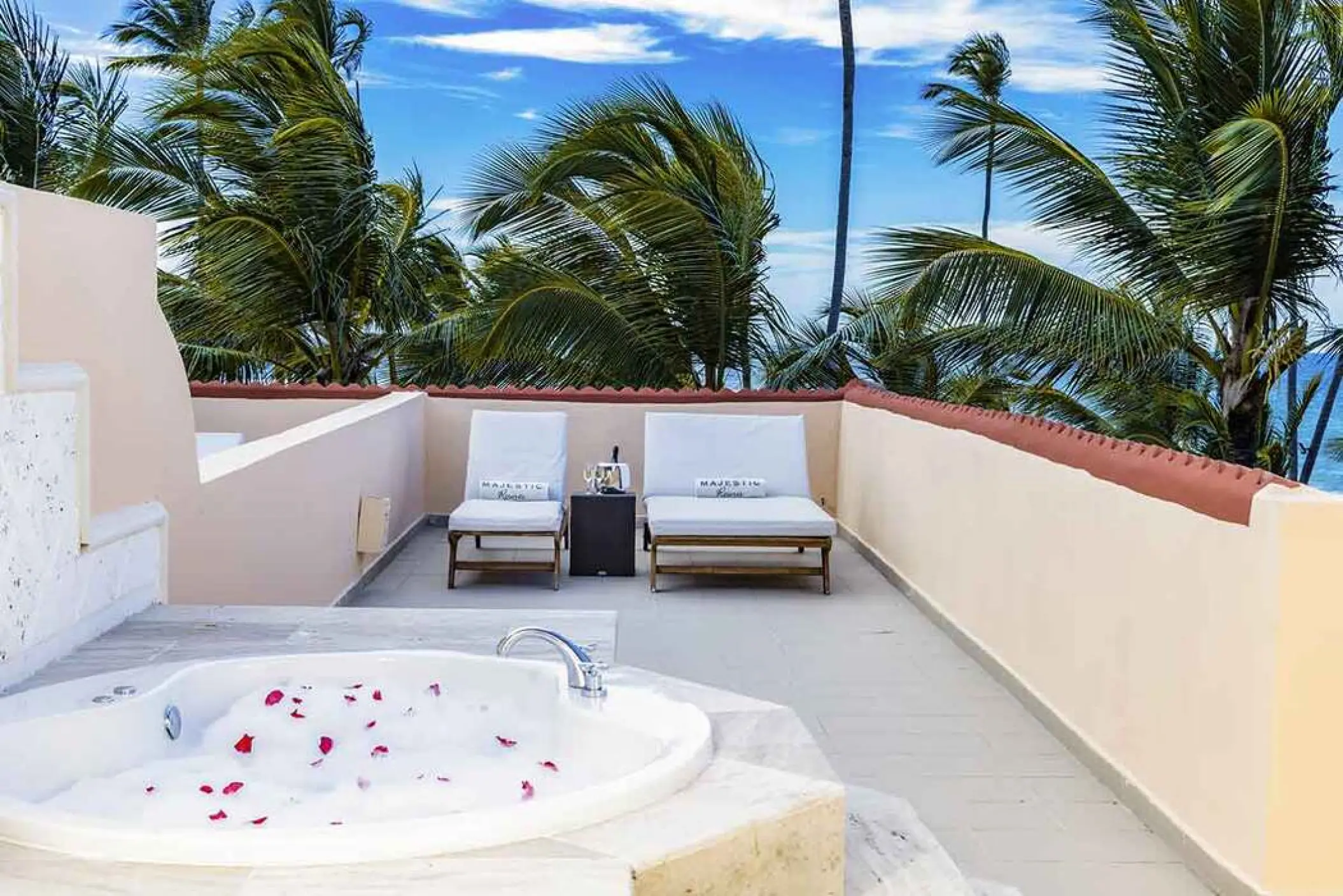 Private suite terrace with whirlpool and sun loungers at Majestic Colonial, Punta Cana