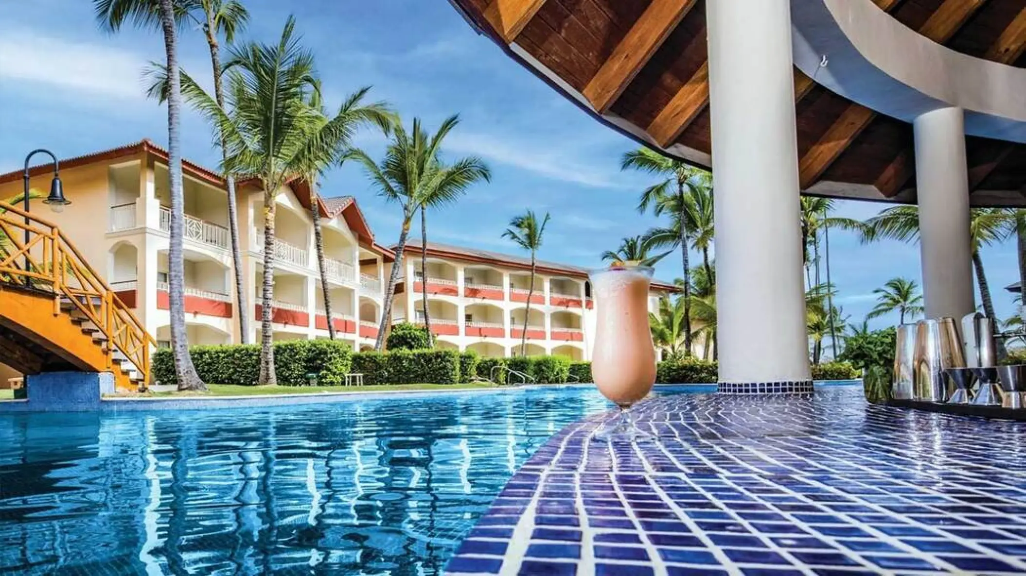 Swim-up bar with tropical cocktail at Majestic Colonial, Punta Cana