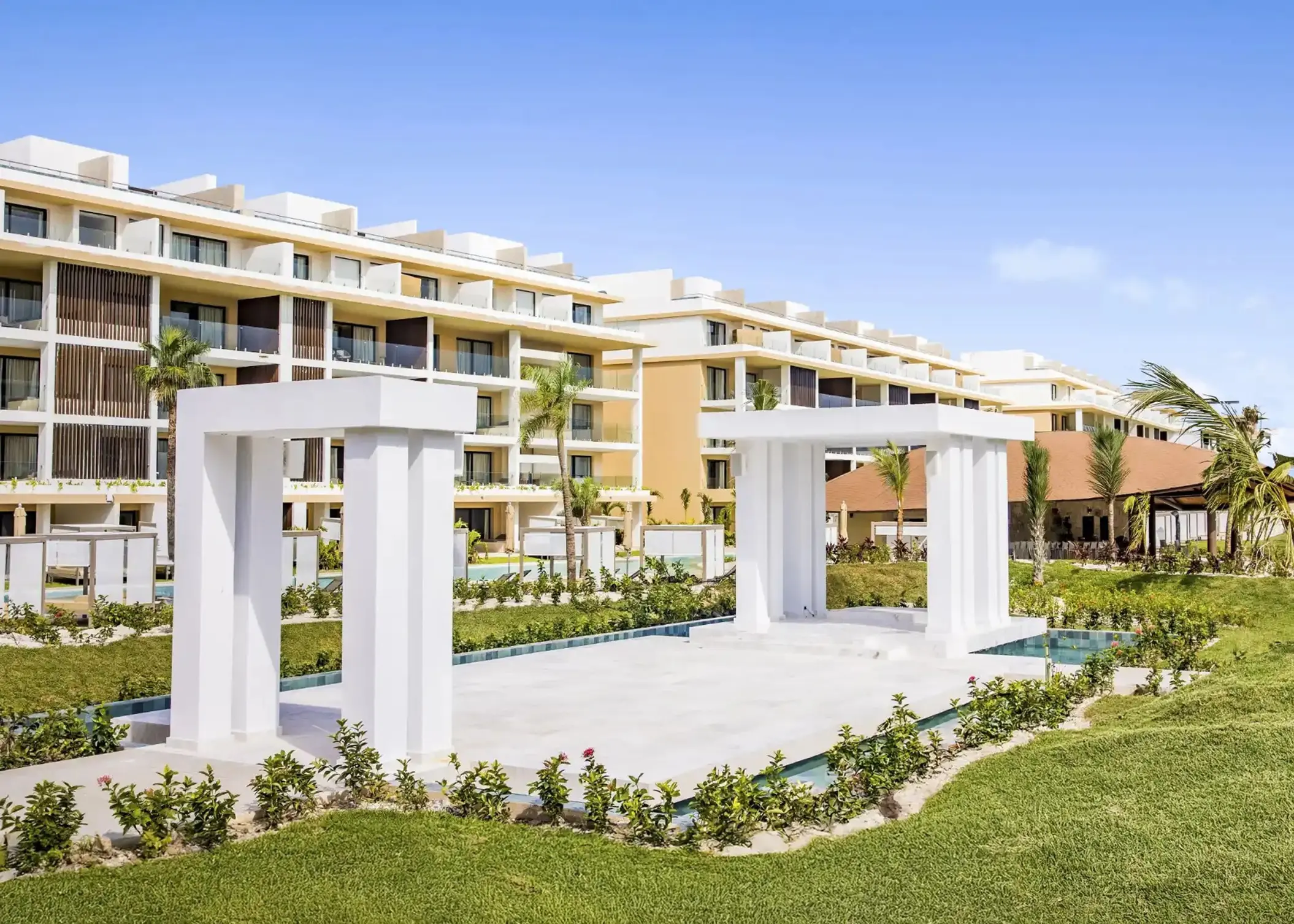 White garden structures and resort buildings at Majestic Mirage, Cancun