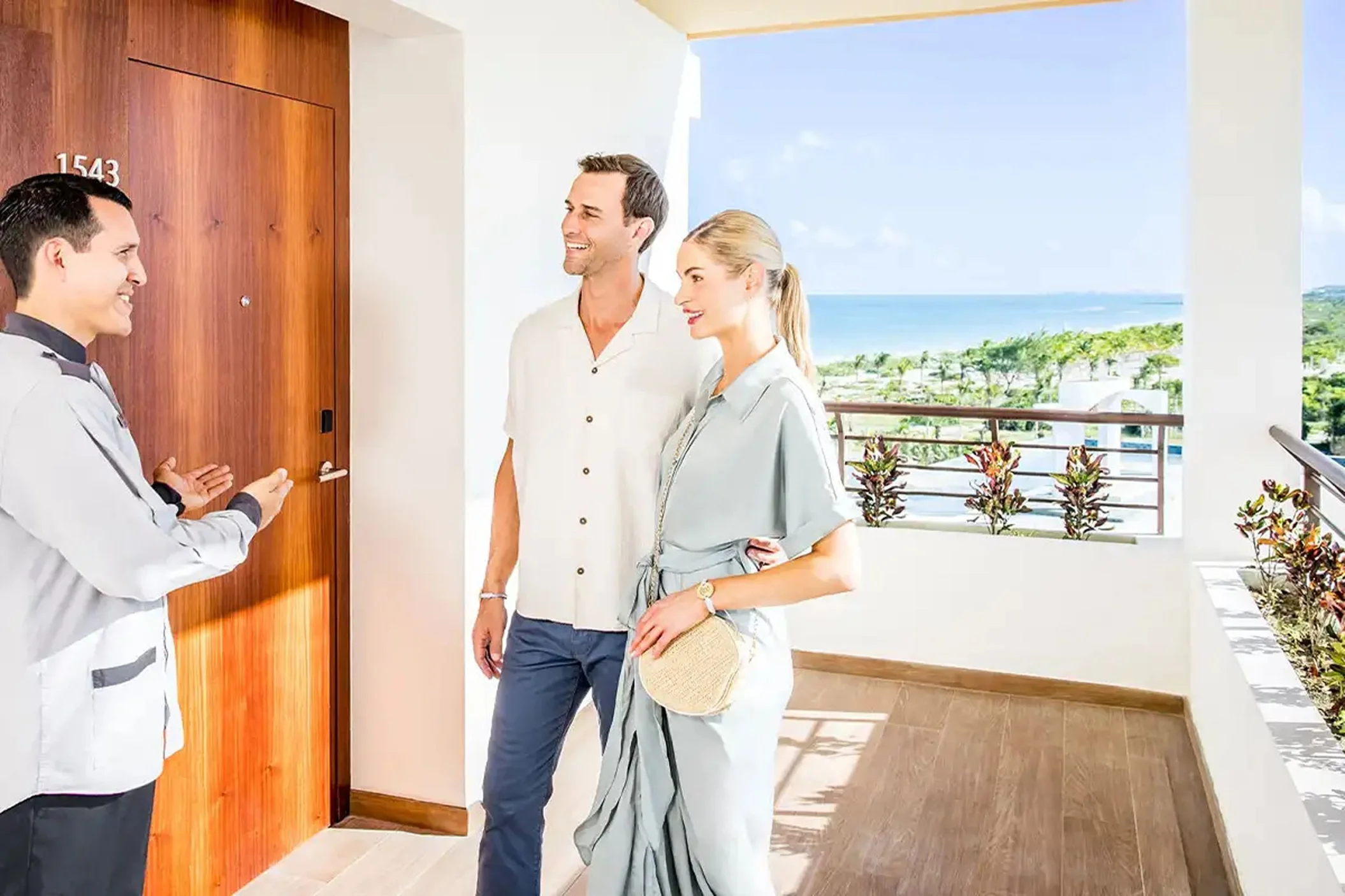 couple being shown to their suite by resort staff at Majestic Mirage Costa Mujeres
