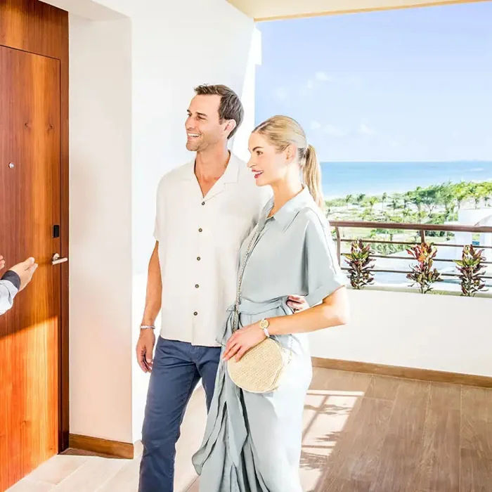 couple being shown to their suite by resort staff at Majestic Mirage Costa Mujeres