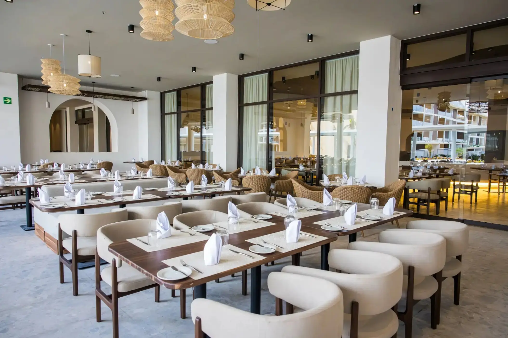 Modern restaurant dining area with woven pendant lights at Majestic Mirage Costa Mujeres, Cancun