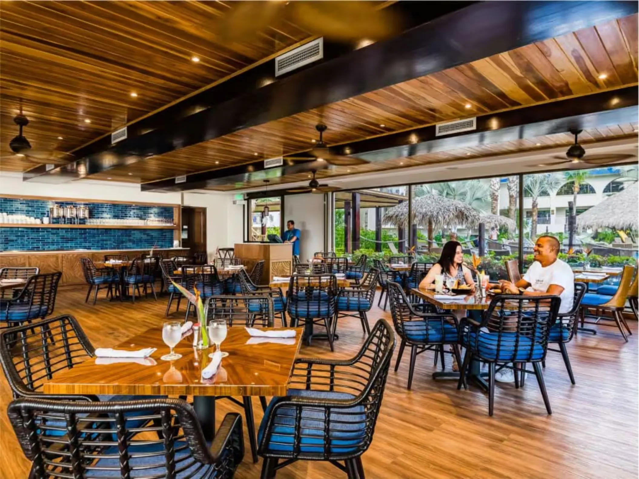 Banana Wind Cafe dining area with wooden ceilings and blue accents at Margaritaville Playa Flamingo, Liberia