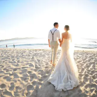 Bride and groom walking on the sand at Margaritaville Beach Resort Playa Flamingo, Liberia