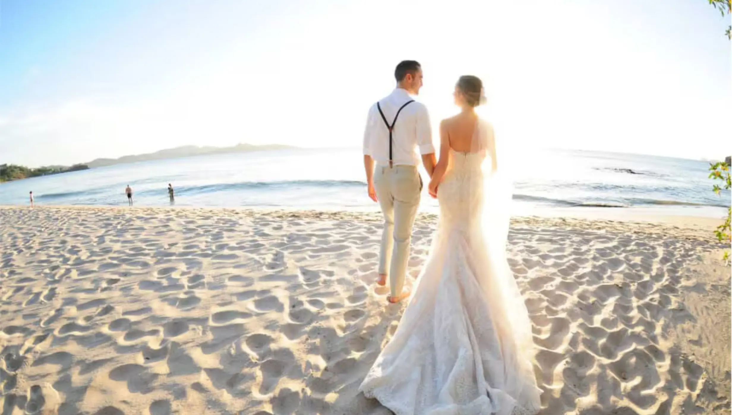 Bride and groom walking on the sand at Margaritaville Beach Resort Playa Flamingo, Liberia