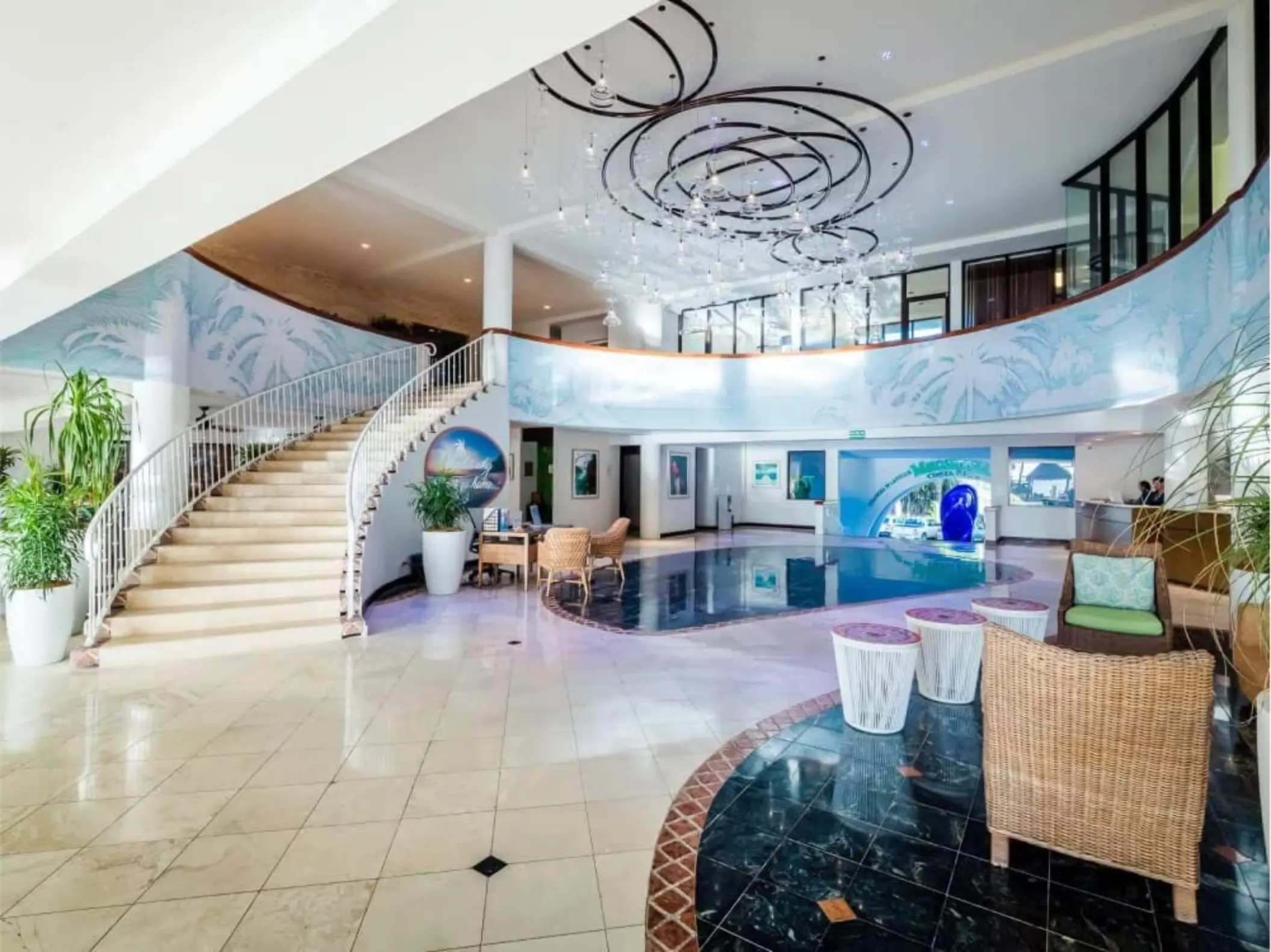 Margaritaville Beach Resort Playa Flamingo lobby featuring a grand staircase and modern chandelier, Liberia
