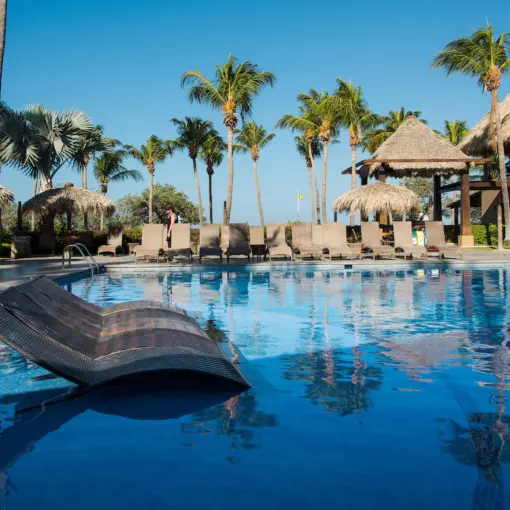 Margaritaville Beach Resort Playa Flamingo pool with in-water loungers and thatched umbrellas, Liberia
