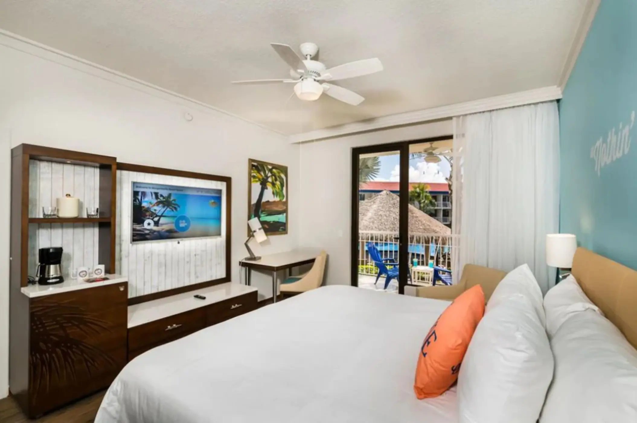 Margaritaville Playa Flamingo guest room with king bed, television, and balcony, Liberia