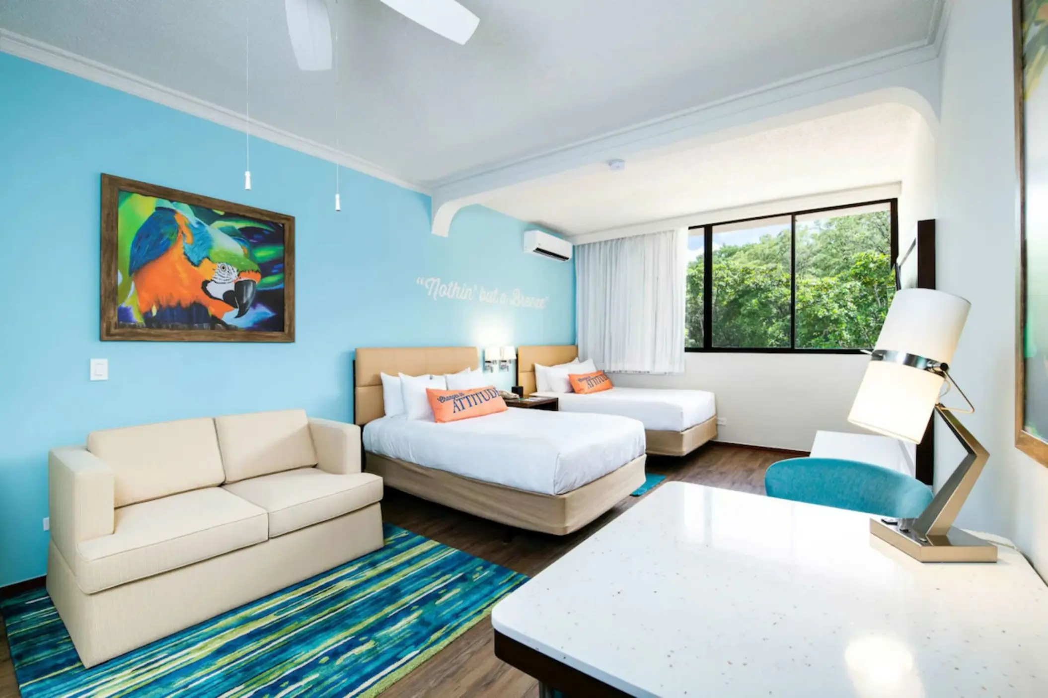 Guest room with two beds and a blue accent wall at Margaritaville Beach Resort Playa Flamingo, Liberia