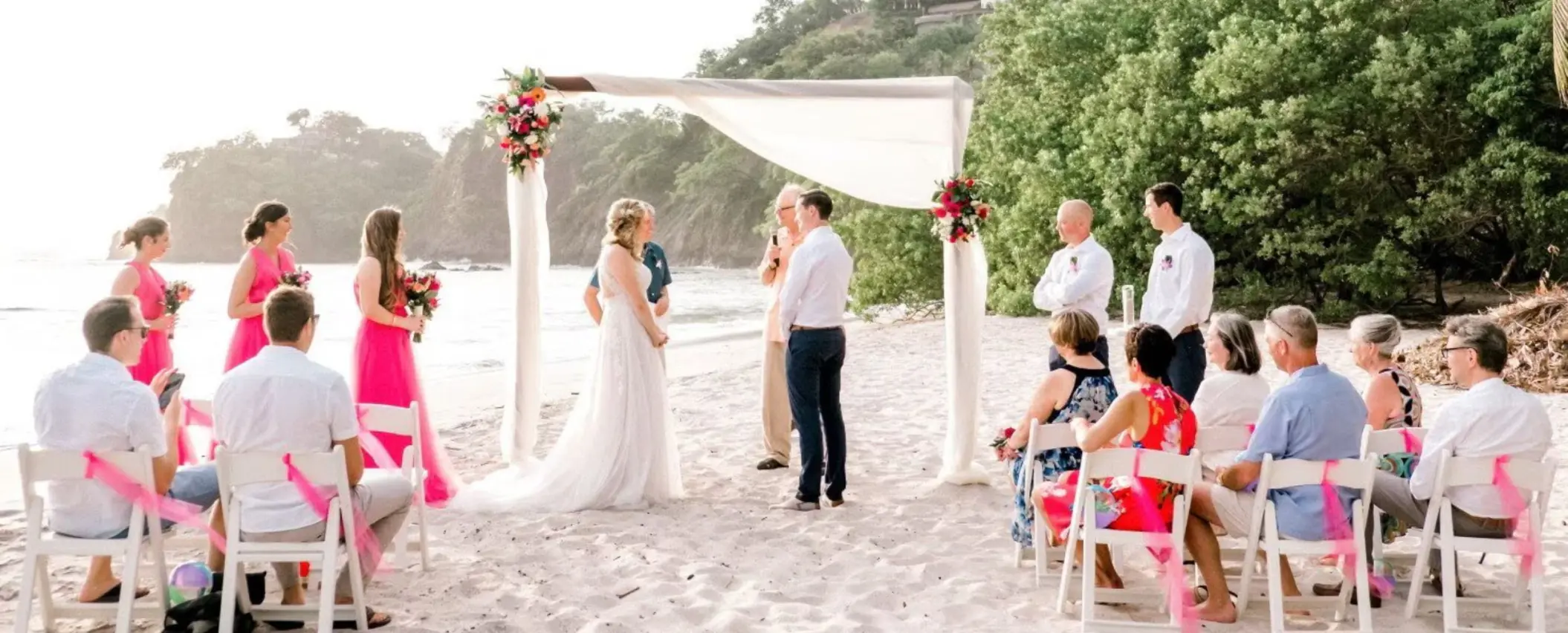 Beachfront wedding ceremony under a white canopy at Margaritaville Playa Flamingo, Liberia