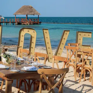 Beachfront wedding reception with LOVE marquee letters at Margaritaville Island Reserve Riviera Cancun