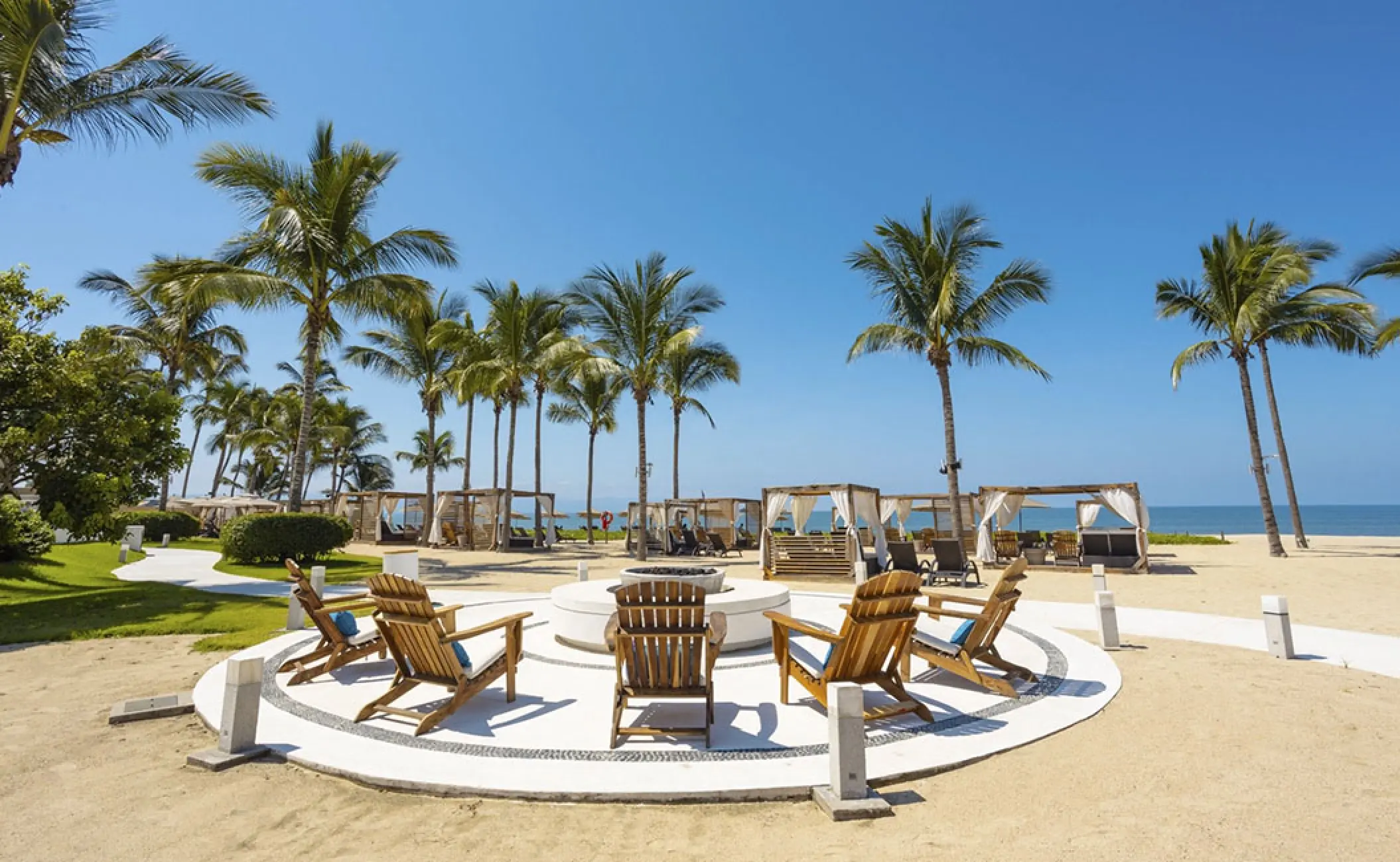 Beachfront fire pit area and cabanas at Marival Distinct, Puerto Vallarta