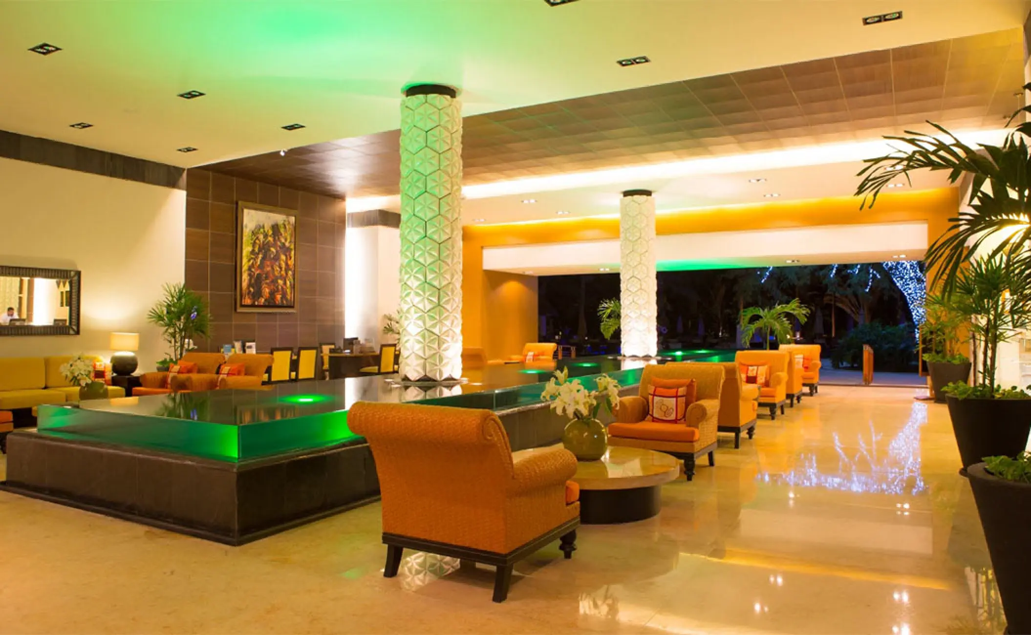 Marival Distinct lobby lounge with orange armchairs and glowing green water feature, Puerto Vallarta