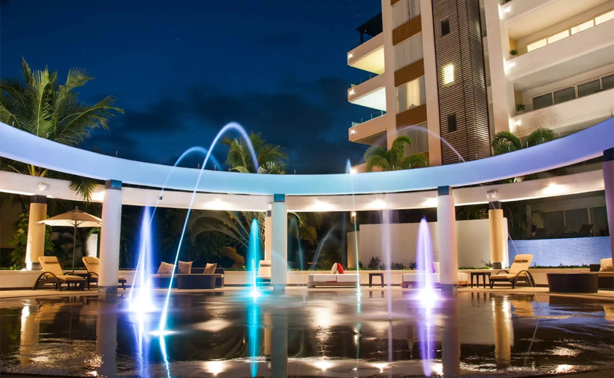Marival Distinct Residences courtyard with illuminated water fountains at night, Puerto Vallarta