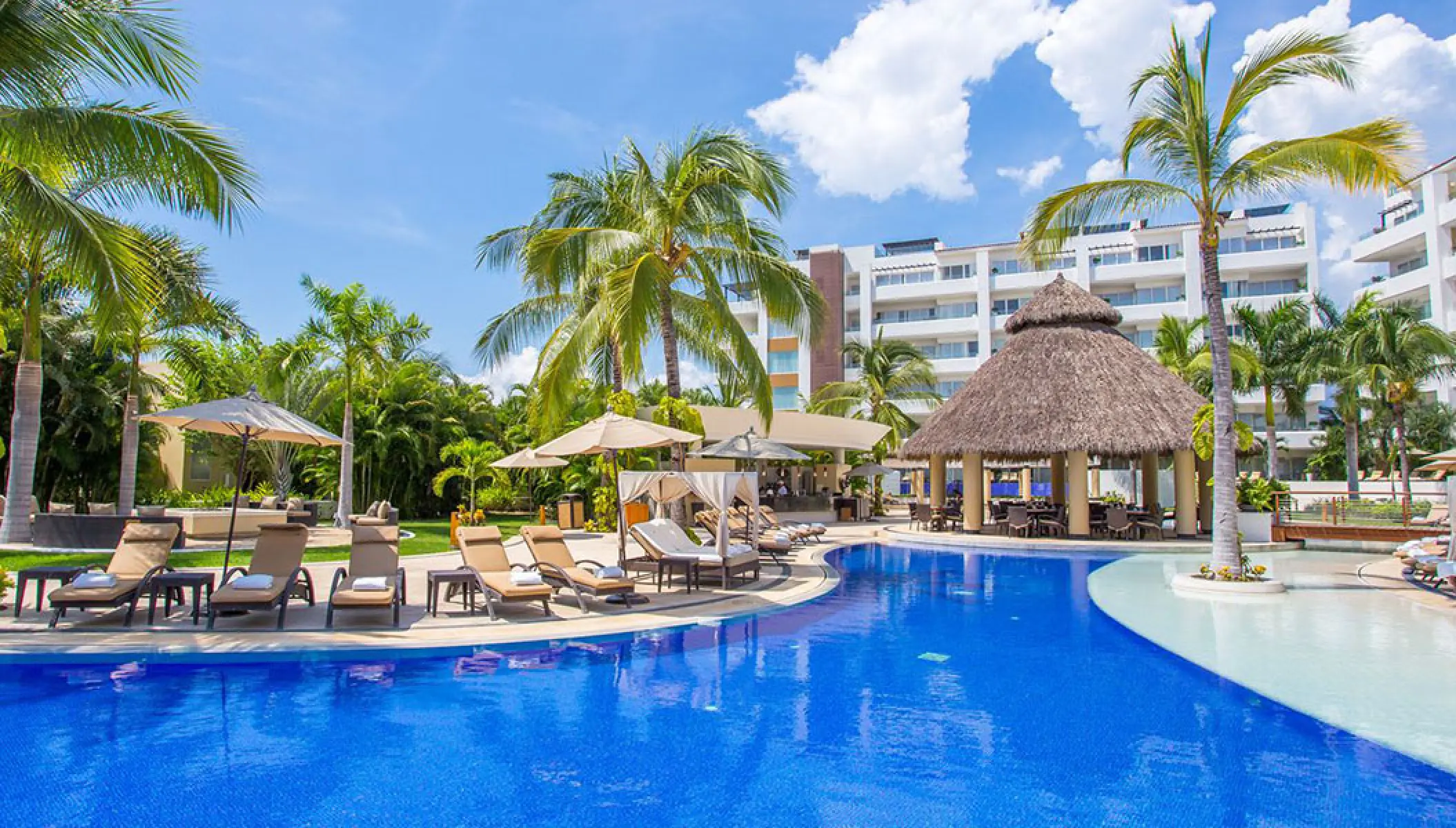 Marival Distinct pool area with a thatched-roof swim-up bar and lounge chairs, Puerto Vallarta