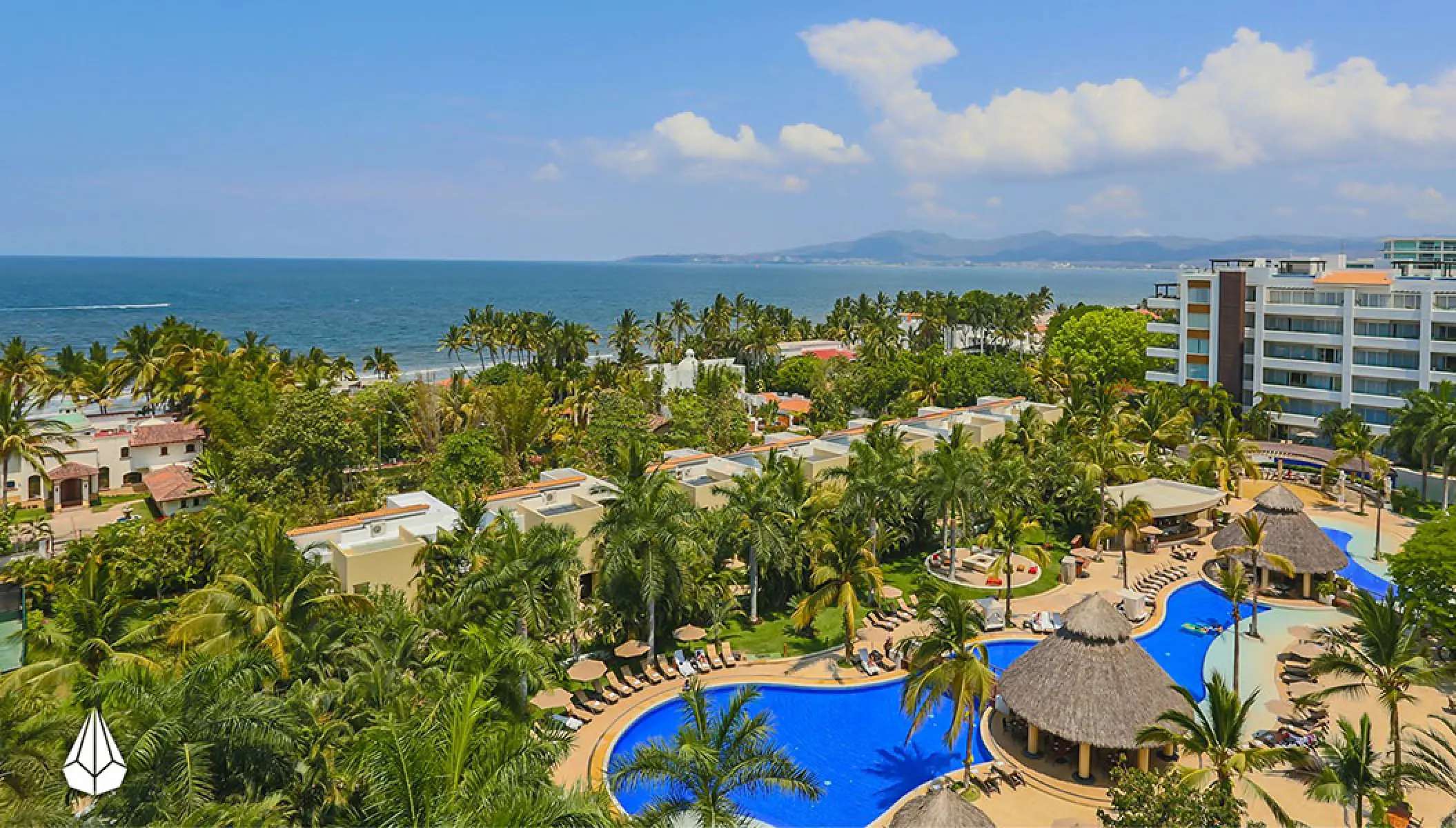 Aerial view of Marival Distinct residences and swimming pools surrounded by palm trees in Puerto Vallarta