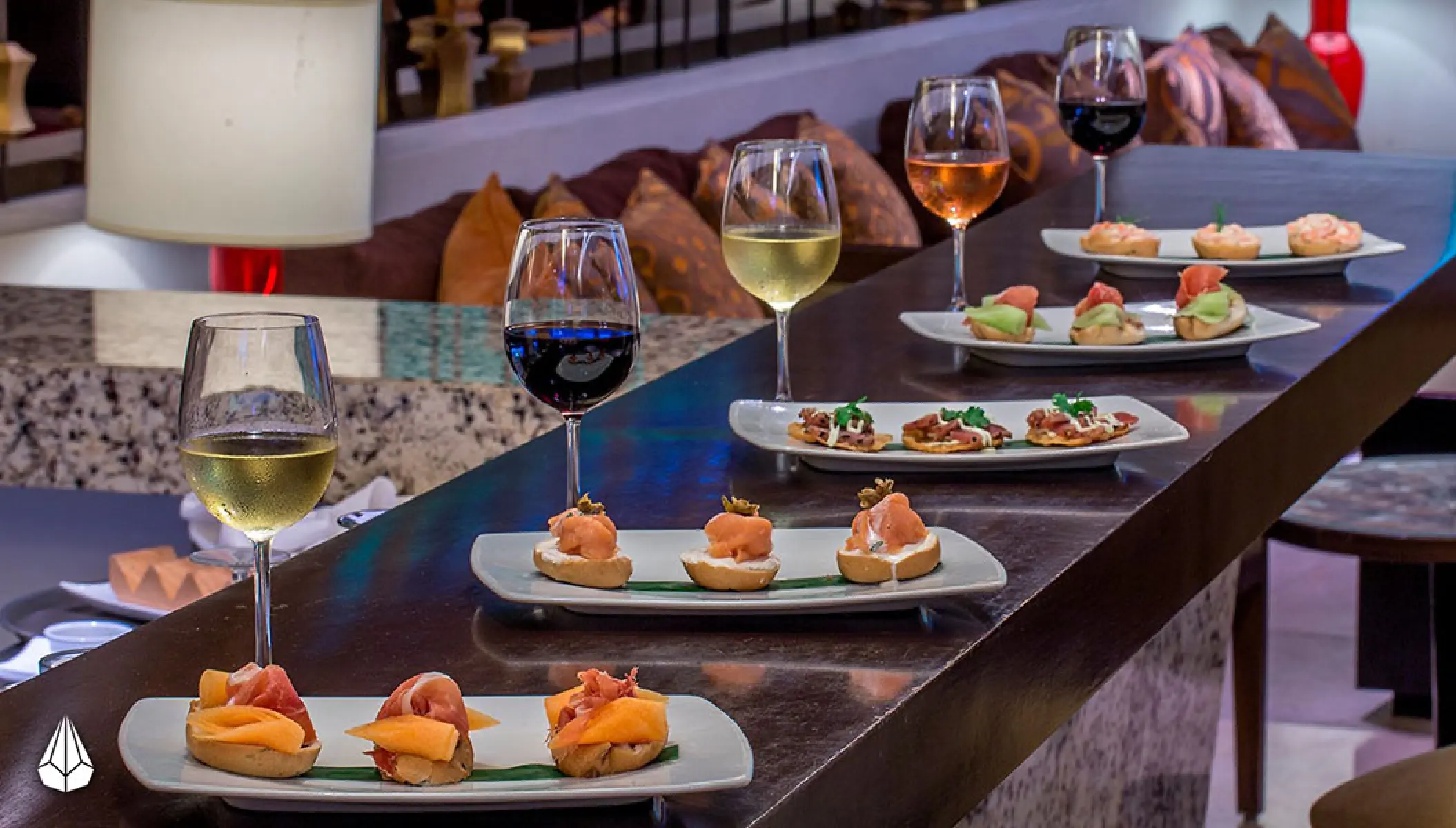 Plates of appetizers and wine glasses at Marival Distinct, Puerto Vallarta