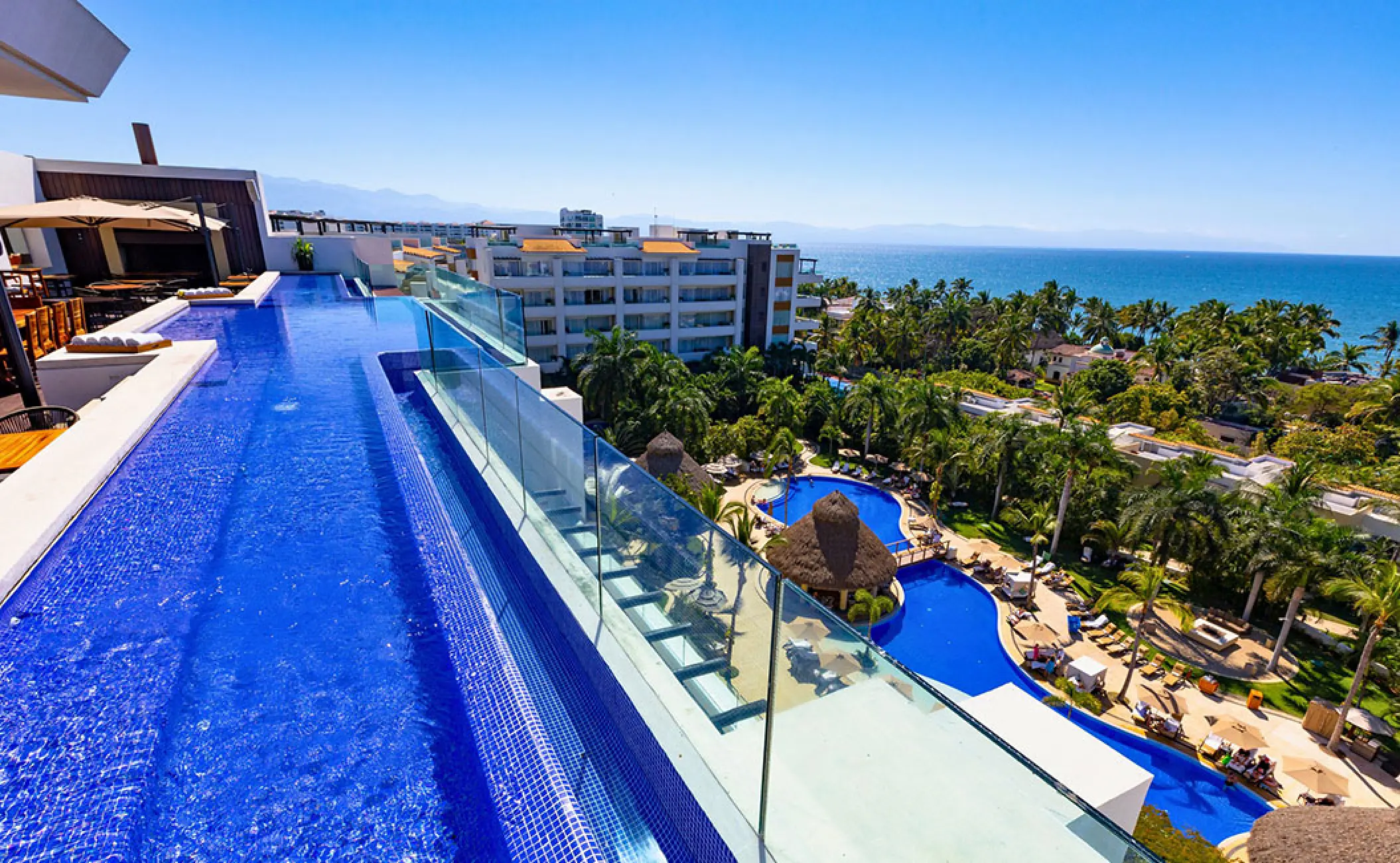 Rooftop infinity pool overlooking the grounds and ocean at Marival Distinct, Puerto Vallarta
