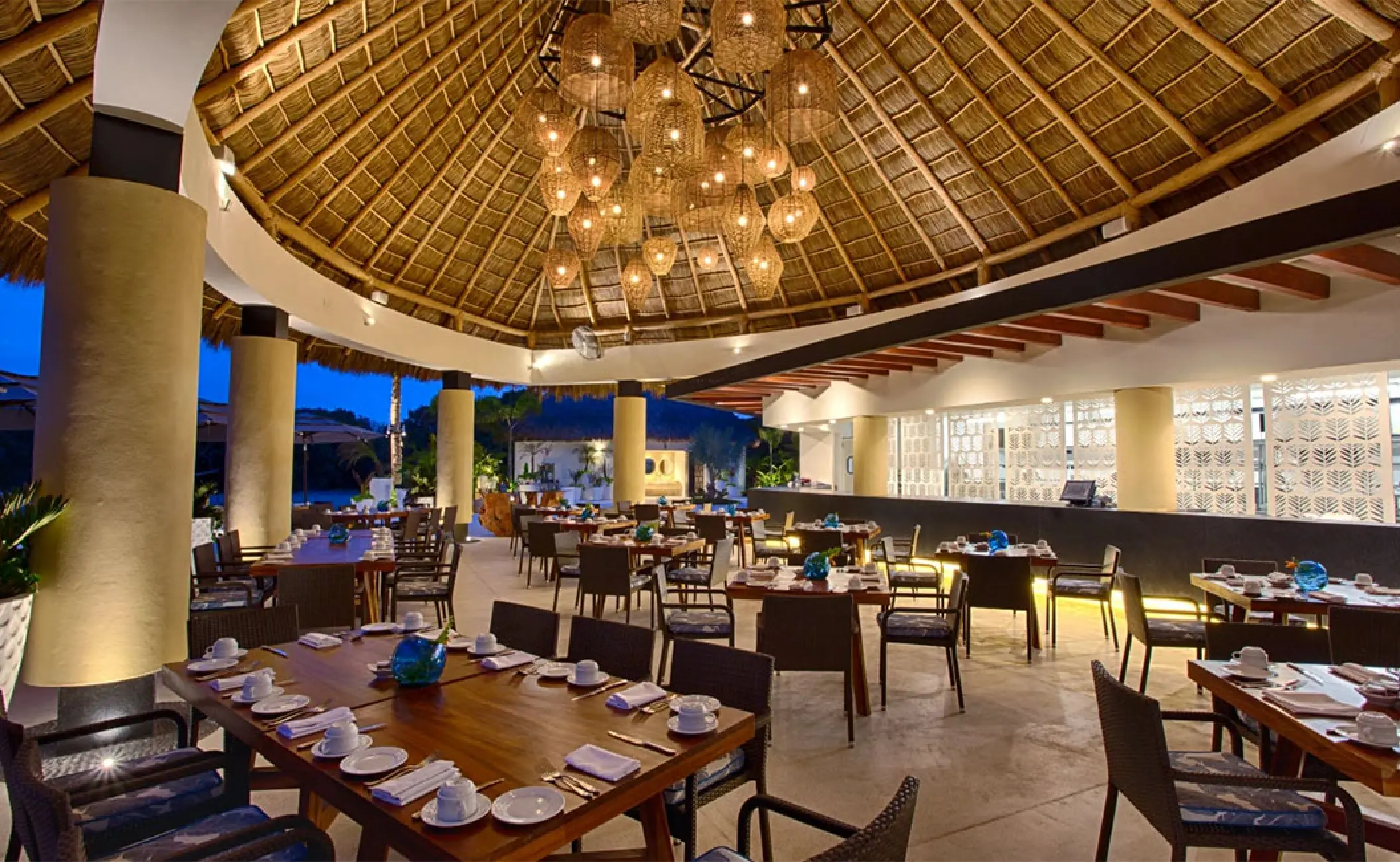 Mozzamare Beach Club restaurant under a palapa roof at Marival Distinct, Puerto Vallarta