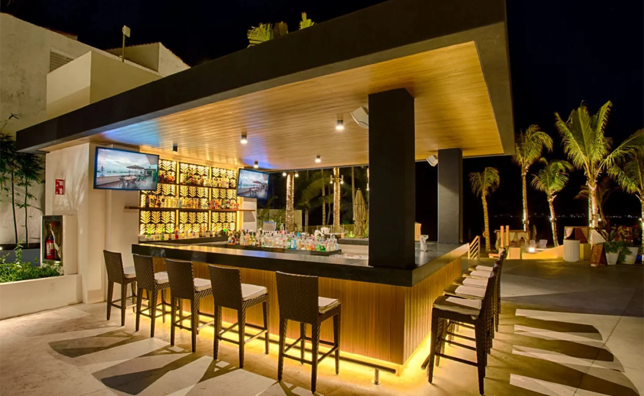 Mozzamare beach club bar lit up at night at Marival Distinct, Puerto Vallarta