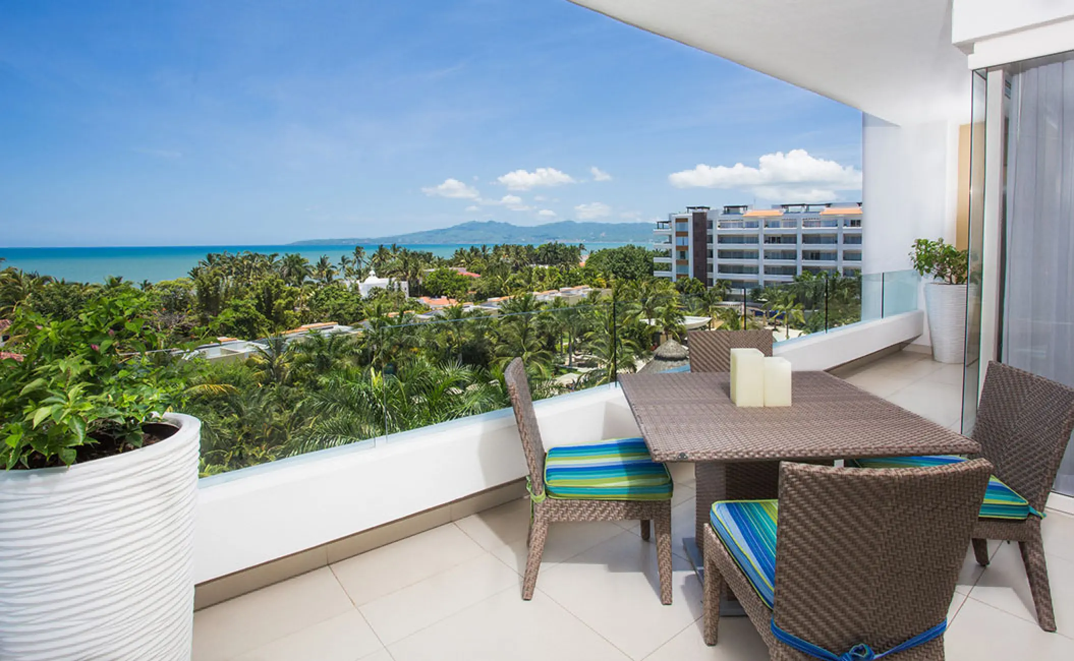 Private balcony with outdoor seating and ocean views at Marival Distinct, Puerto Vallarta