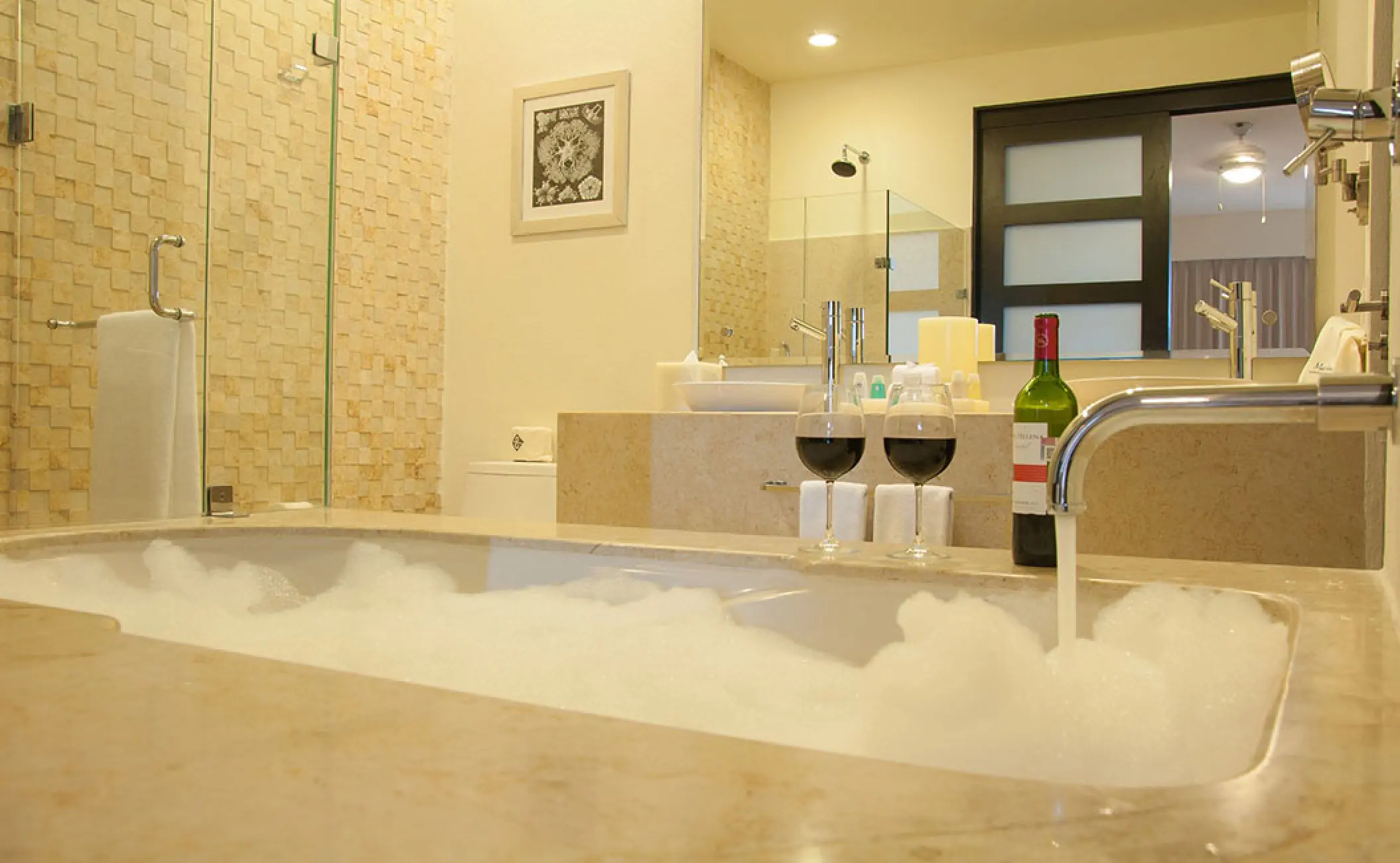 Bubble bath with two glasses of wine in a residence suite at Marival Distinct Residences, Puerto Vallarta