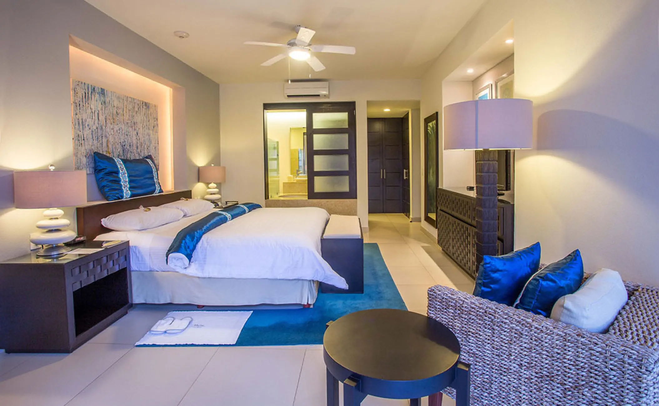 Marival Distinct Residences suite with blue accents and modern furnishings, Puerto Vallarta