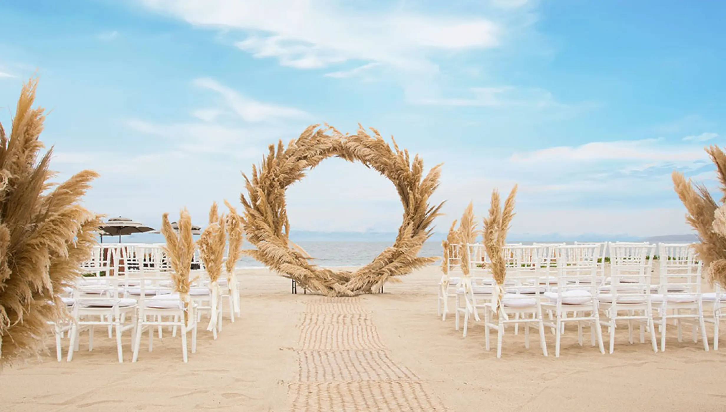 Beach ceremony decor on the beach at Marival Distinct Luxury residences.