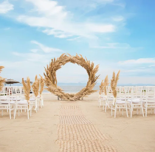 Beach ceremony decor on the beach at Marival Distinct Luxury residences.