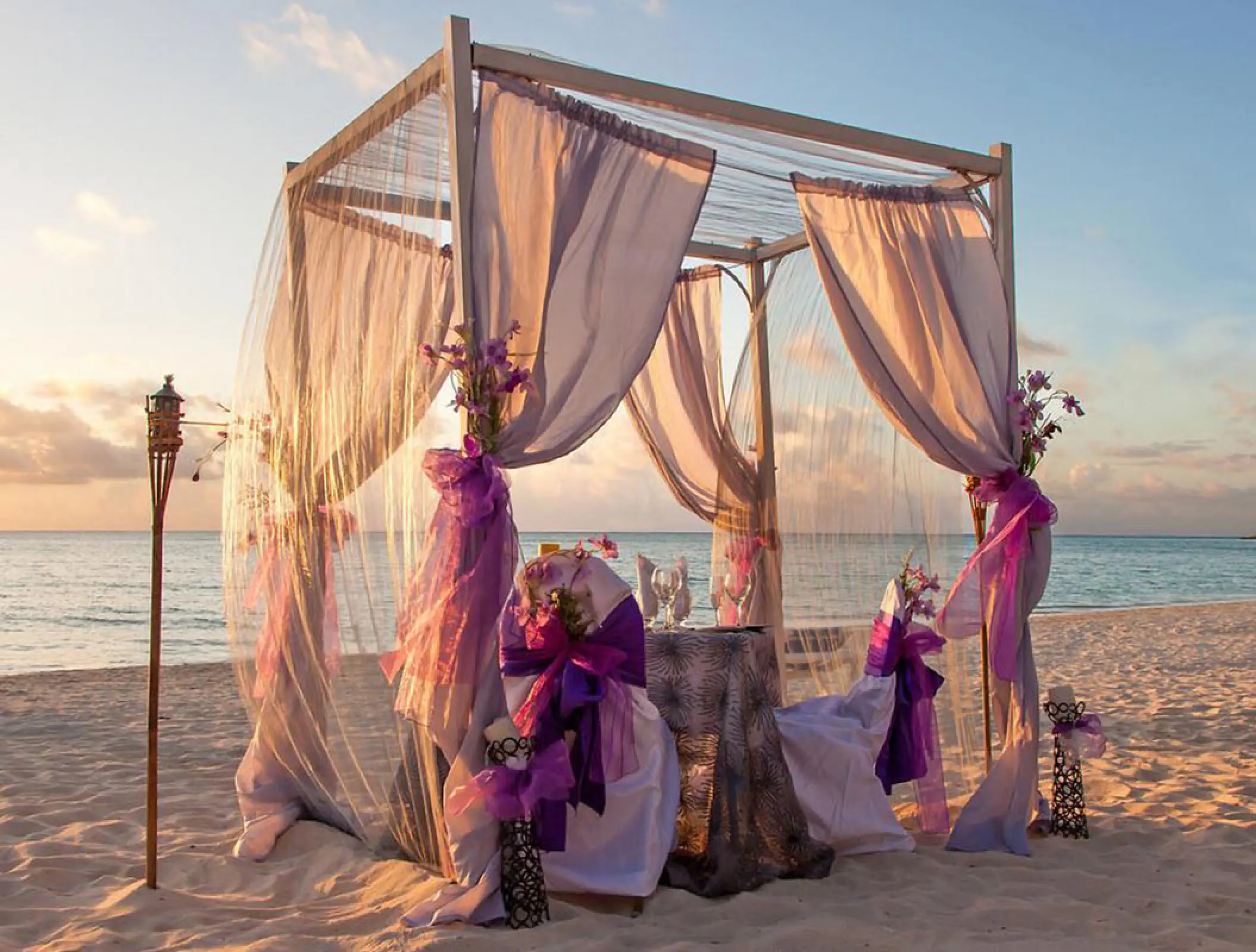 Beachfront wedding ceremony gazebo with purple drapes at Marival Distinct, Puerto Vallarta