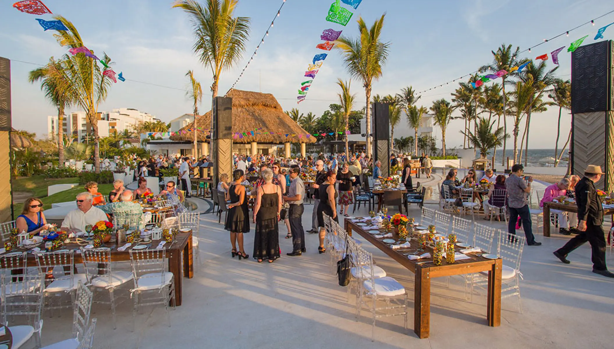 Outdoor wedding reception with colorful bunting at Marival Distinct, Puerto Vallarta