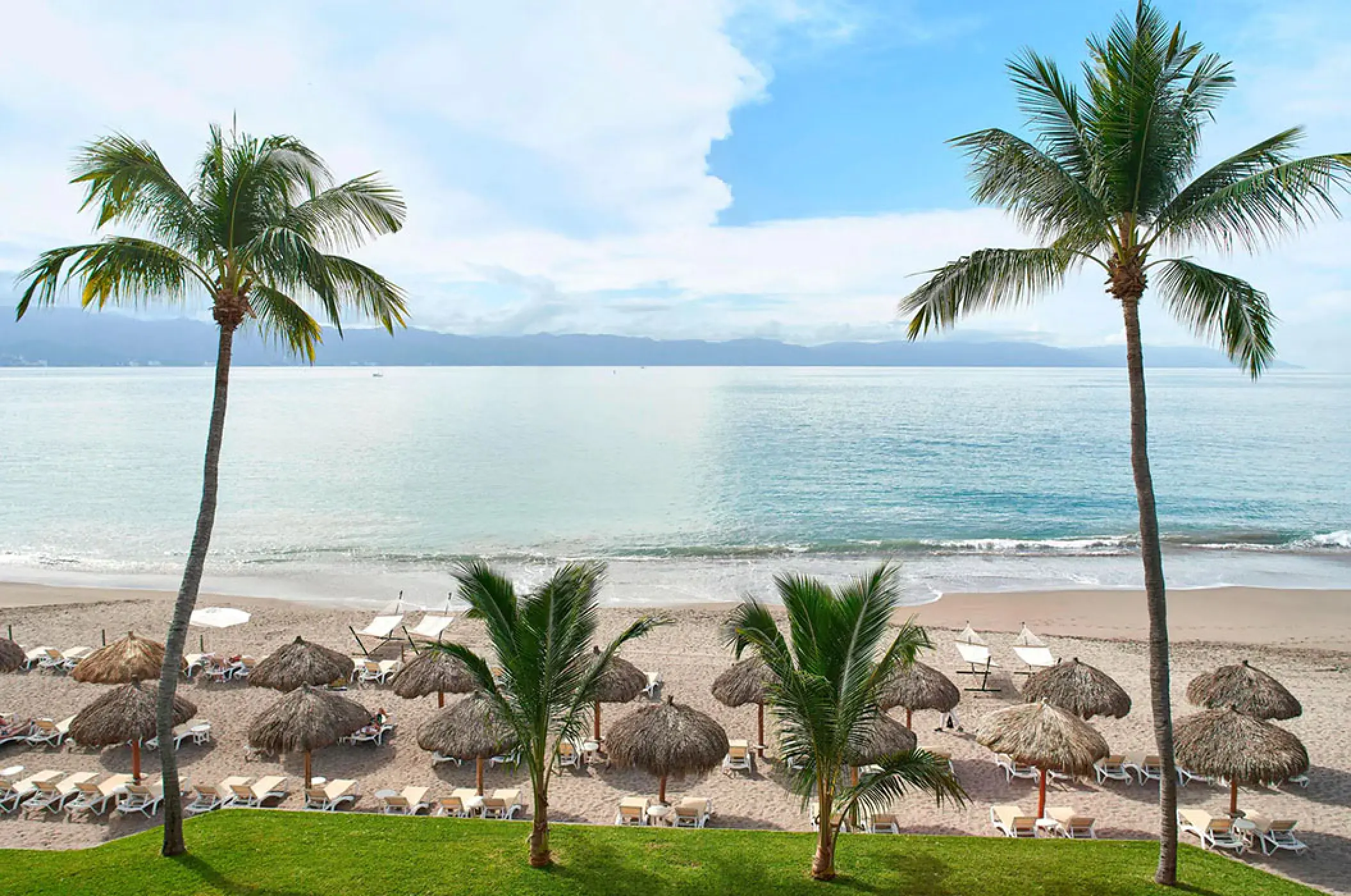 Marriott Puerto Vallarta beach with palm trees and palapas overlooking Banderas Bay, Puerto Vallarta